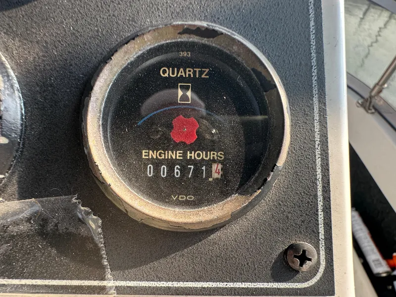 Slide: The Image of 1993 Carver 350 Aft Cabin engine hour meter showing 671.4 hours. - 5