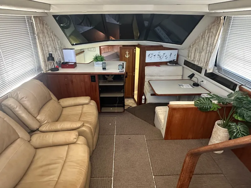 Slide: The Image of Interior of 1993 Carver 350 Aft Cabin with beige seating and dining area. - 8
