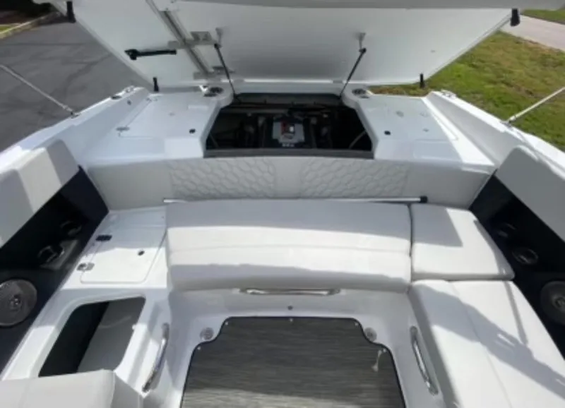 Slide: The Image of 2025 Four Winns H2 Freedom boat interior with open engine compartment and white seating. - 10