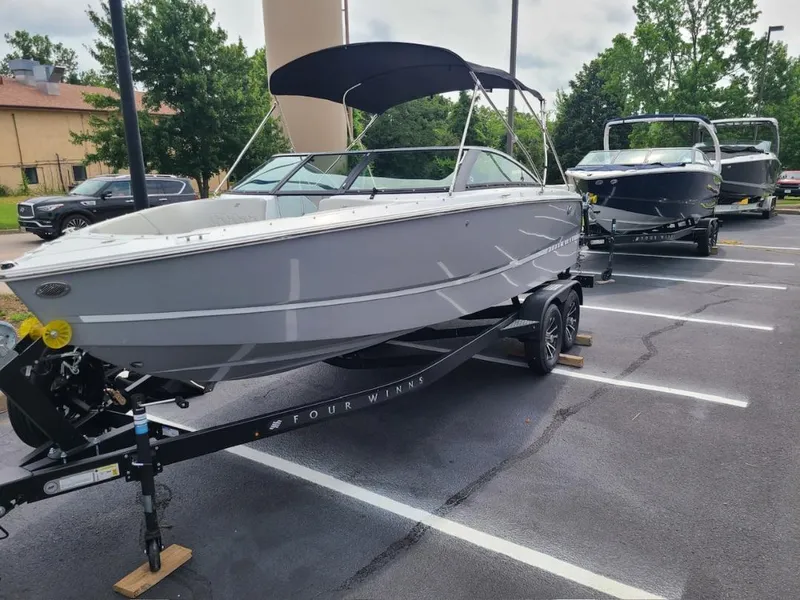Slide: The Image of 2025 Four Winns H2 Freedom boat on trailer in parking lot. - 2
