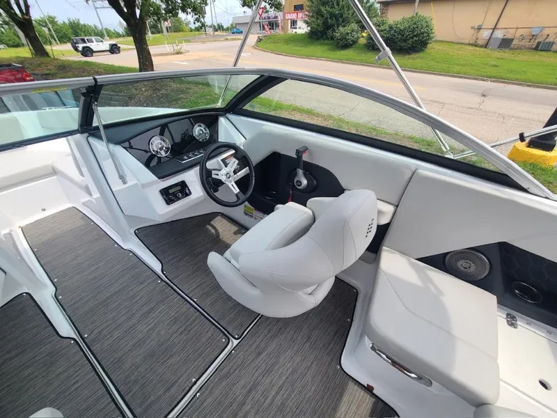Slide: The Image of 2025 Four Winns H2 Freedom boat interior with modern dashboard and seating. - 5