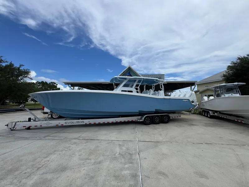 The Image of 2026 Invincible 43 Open Fisherman boat on trailer, parked outdoors under cloudy sky. - 1