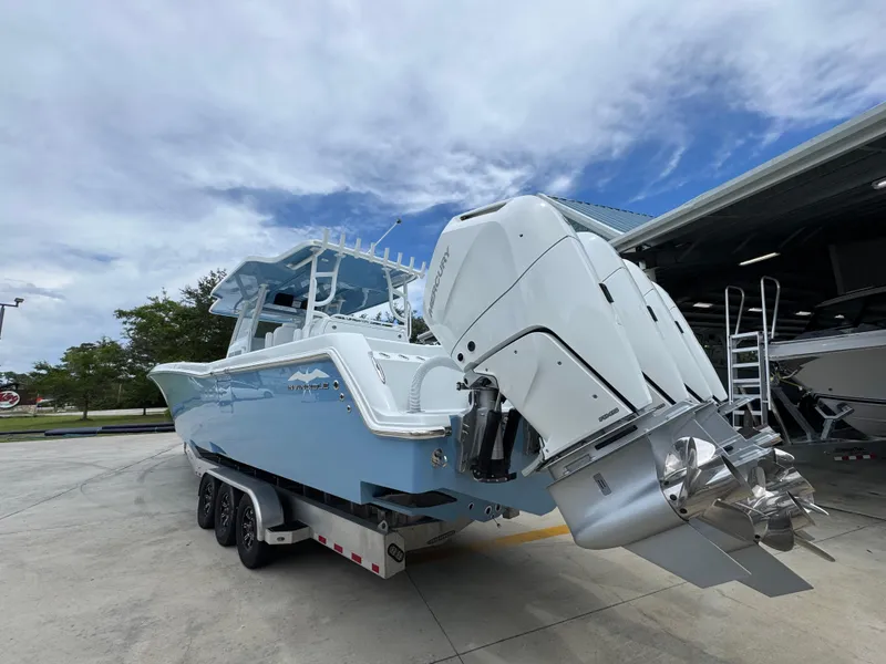 Slide: The Image of 2026 Invincible 43 Open Fisherman boat with powerful outboard engines, parked outdoors. - 11