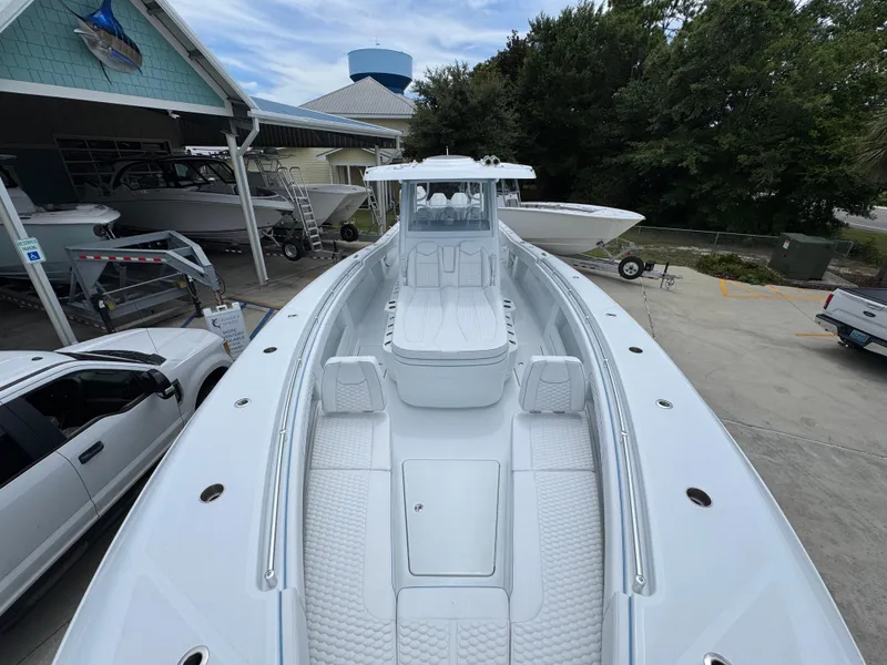 Slide: The Image of 2026 Invincible 43 Open Fisherman boat at a marina, showcasing spacious deck and seating. - 18