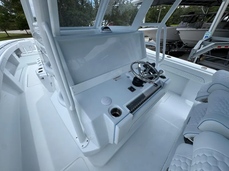 Slide: The Image of 2026 Invincible 43 Open Fisherman boat interior with steering console and seating. - 25