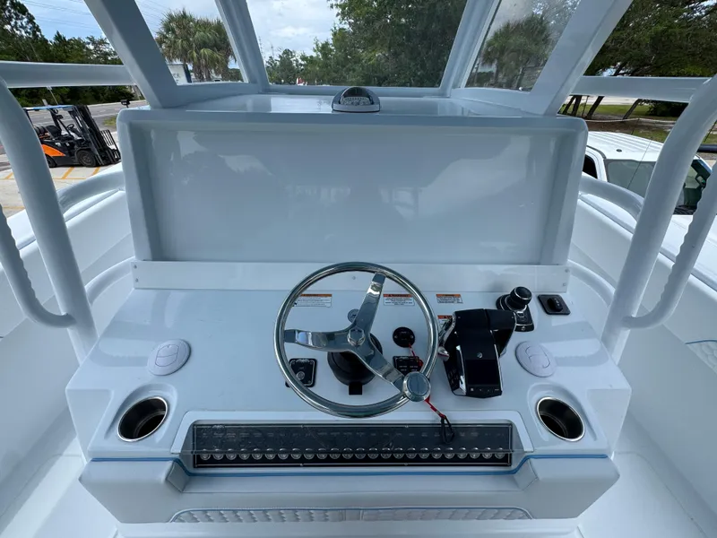 Slide: The Image of Invincible 43 Open Fisherman 2026 helm with steering wheel and controls. - 26