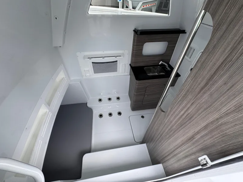Slide: The Image of Interior of 2026 Invincible 43 Open Fisherman boat, featuring a compact sink and modern design. - 28