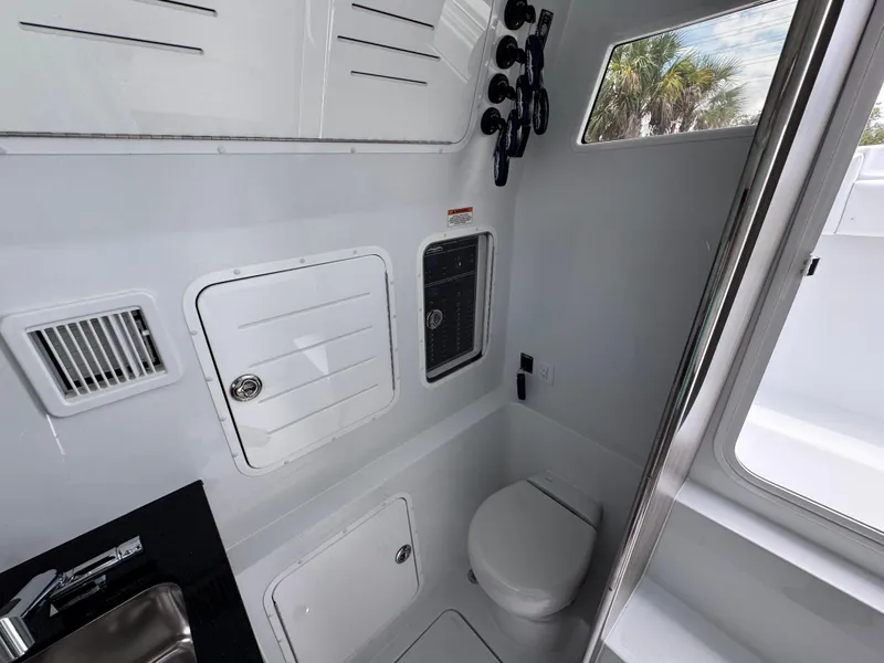 Slide: The Image of Interior of 2026 Invincible 43 Open Fisherman boat, featuring a compact bathroom with modern amenities. - 30