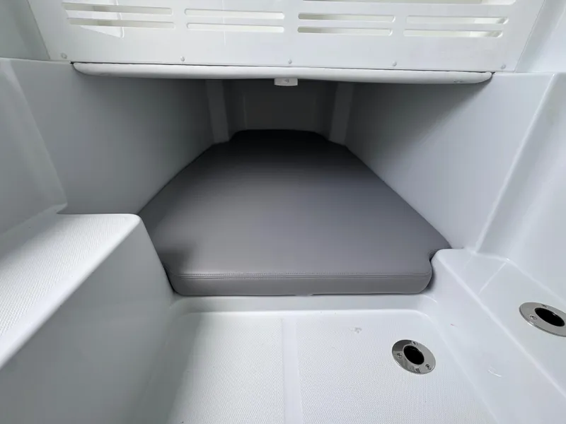 Slide: The Image of Interior cabin of 2026 Invincible 43 Open Fisherman boat, featuring a cushioned sleeping area. - 31