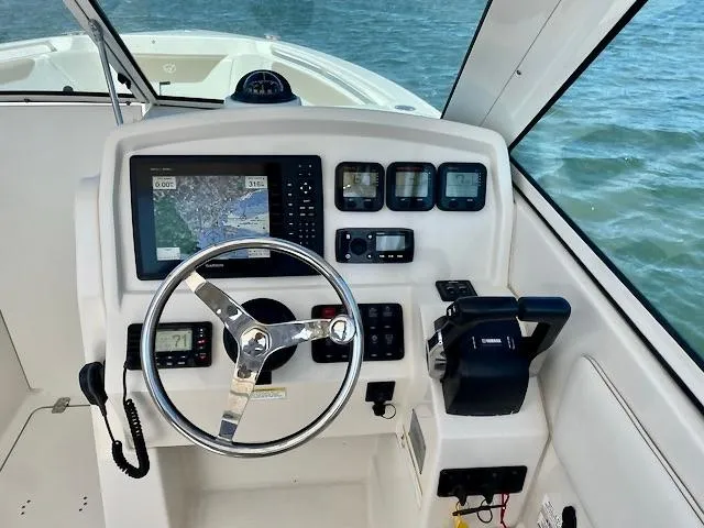 Slide: The Image of Control panel of a 2015 Sailfish 275 DC boat with navigation equipment. - 12