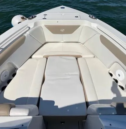 Slide: The Image of 2015 Sailfish 275 DC boat with spacious seating and sleek design on the water. - 15
