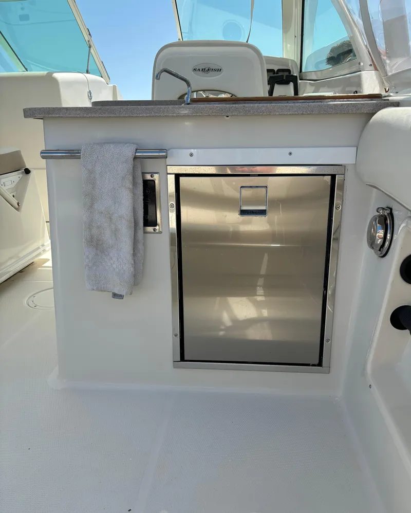 Slide: The Image of 2015 Sailfish 275 DC boat interior with sink and stainless steel cabinet. - 16