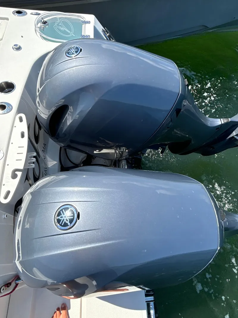 Slide: The Image of Twin Yamaha outboard motors on a 2015 Sailfish 275 DC boat in water. - 8