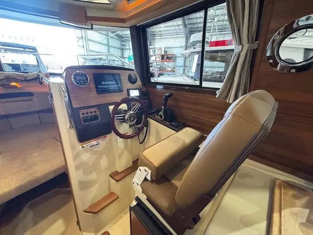 Slide: The Image of Interior of 2025 Ranger Tugs R-23 boat with steering wheel and navigation system. - 7