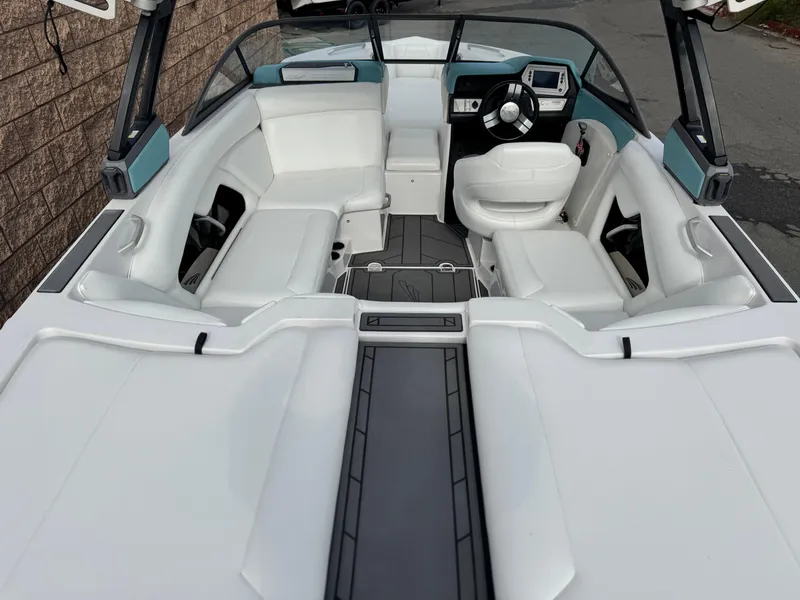Slide: The Image of 2019 Tigé R21 boat interior with white seating and modern dashboard. - 11