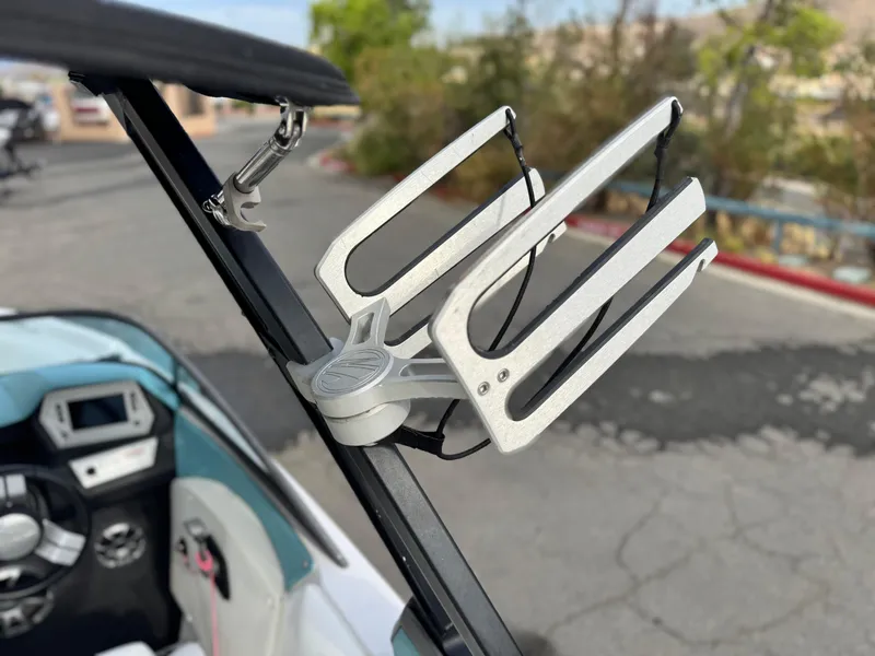 Slide: The Image of 2019 Tigé R21 boat with a sleek wakeboard rack and modern dashboard. - 14