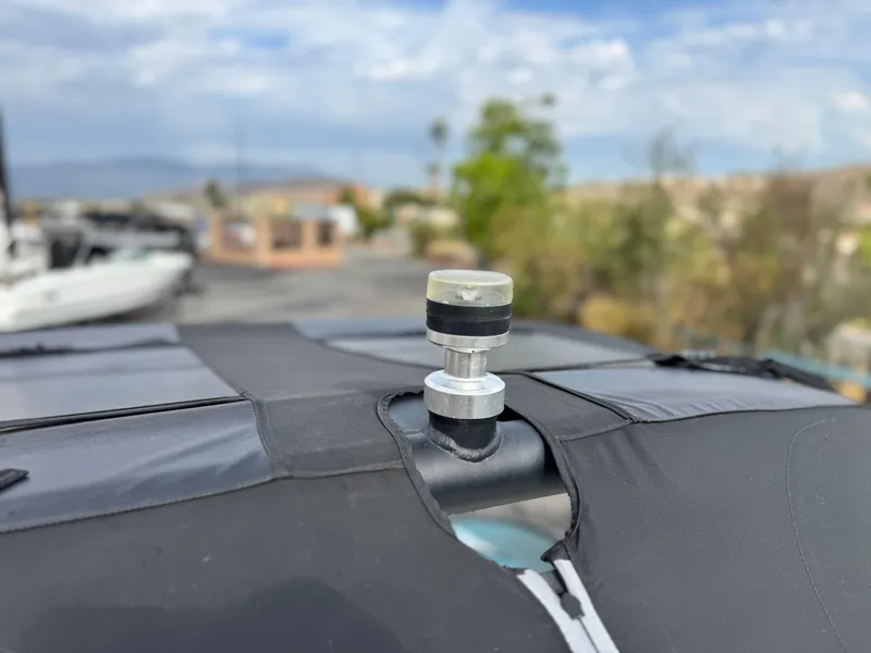 Slide: The Image of 2019 Tigé R21 boat cover with a mounted fitting against a blurred outdoor background. - 15