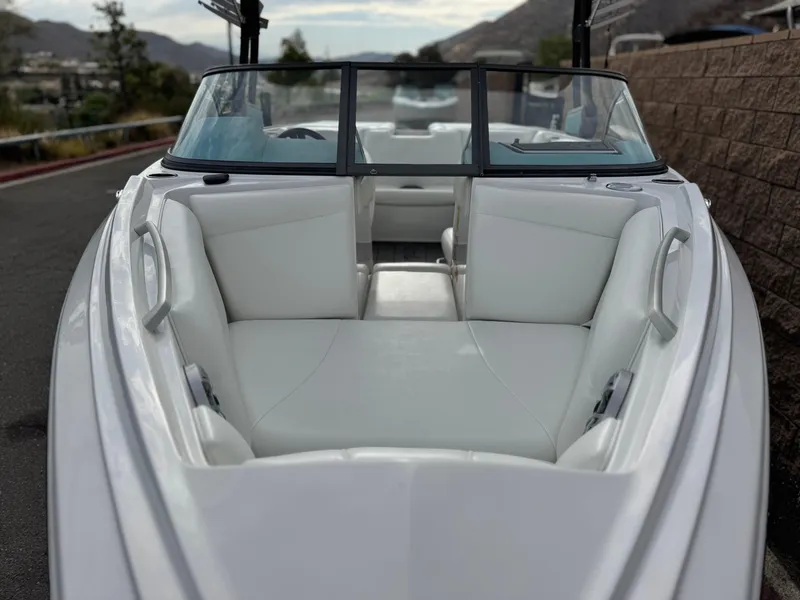 Slide: The Image of 2019 Tigé R21 boat with white interior seating, parked outdoors. - 16