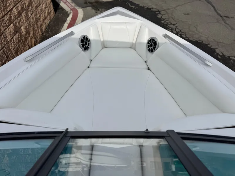 Slide: The Image of 2019 Tigé R21 boat interior with white seating and speakers. - 17