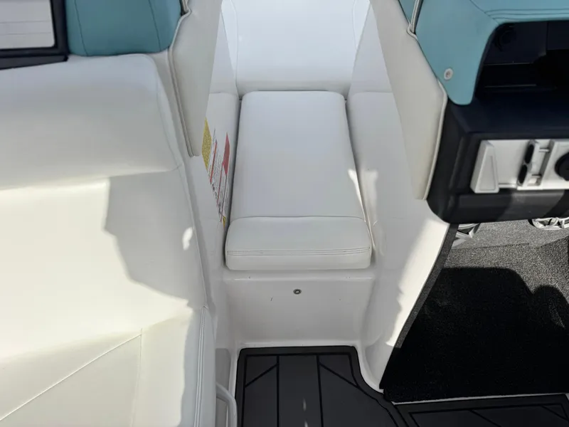 Slide: The Image of 2019 Tigé R21 boat interior with white seating and black flooring. - 18
