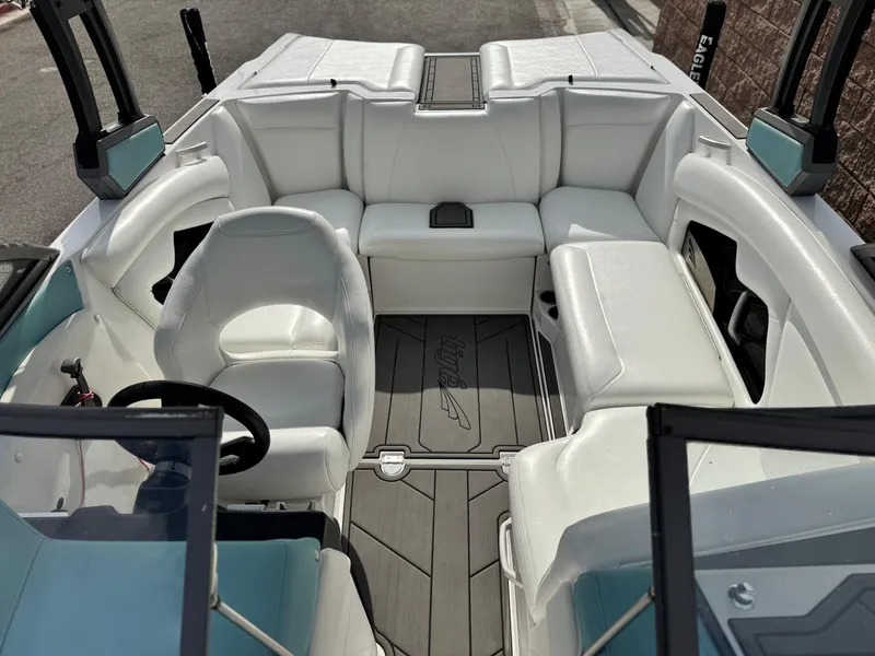 Slide: The Image of 2019 Tigé R21 boat interior with white seating and steering wheel. - 20