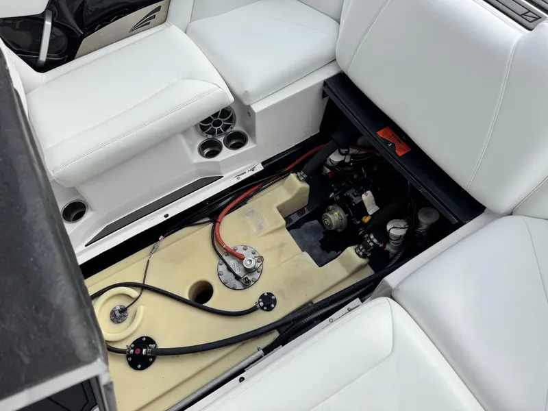 Slide: The Image of 2019 Tigé R21 boat interior showing engine compartment and seating area. - 25