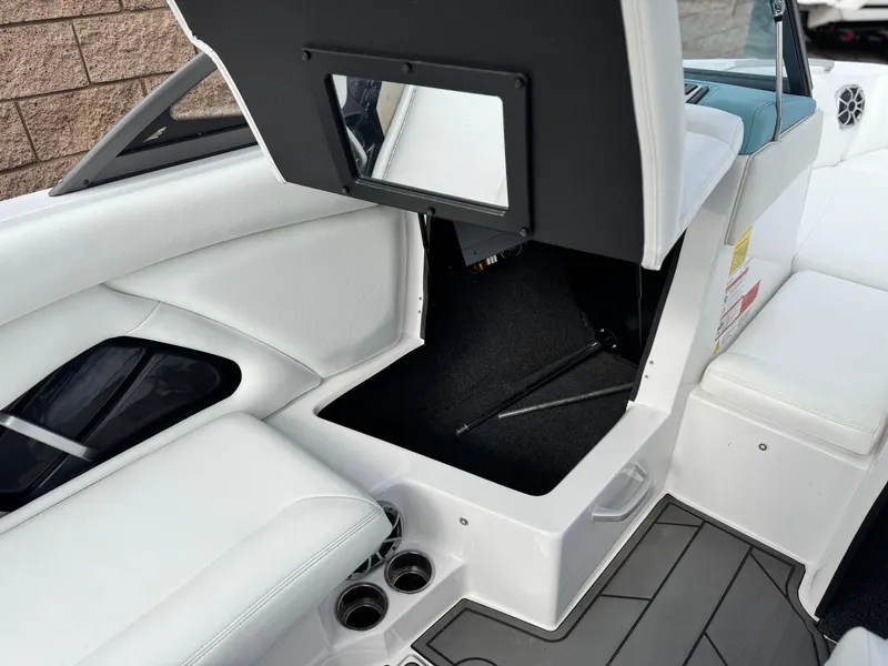 Slide: The Image of 2019 Tigé R21 boat interior with open storage compartment and white seating. - 27