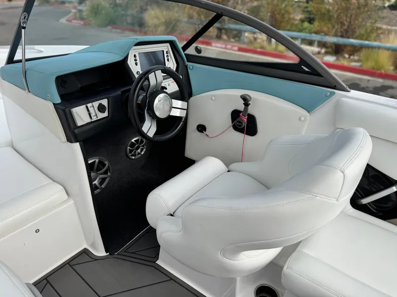 Slide: The Image of 2019 Tigé R21 boat interior with steering wheel and white seating. - 29