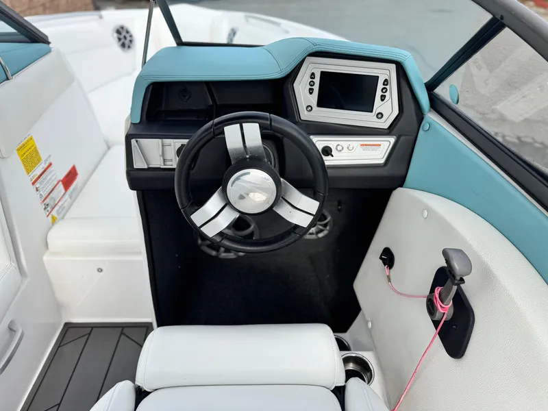 Slide: The Image of 2019 Tigé R21 boat cockpit with steering wheel and control panel. - 30