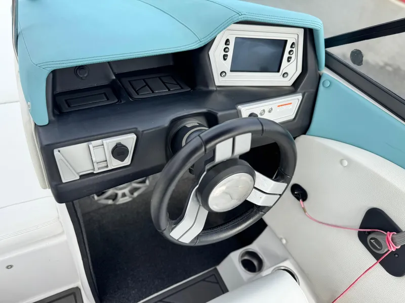 Slide: The Image of 2019 Tigé R21 boat dashboard with steering wheel and control panel. - 31