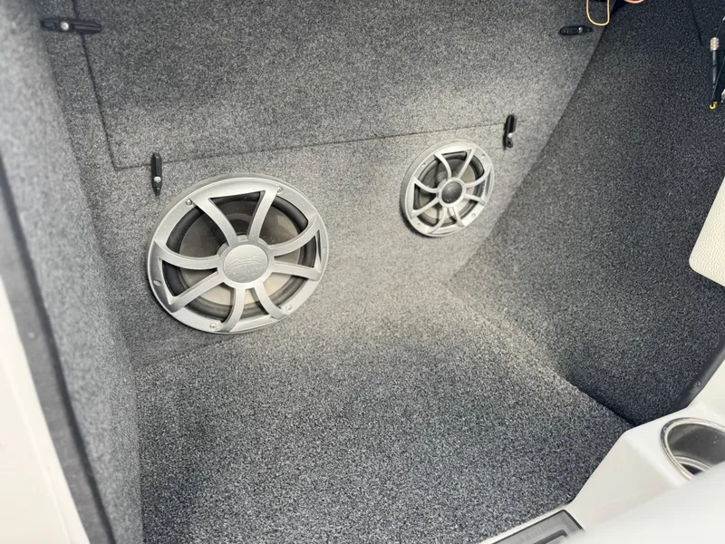 Slide: The Image of 2019 Tigé R21 boat interior with dual speakers installed on carpeted surface. - 32