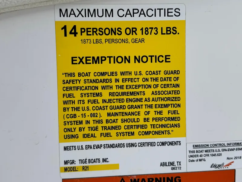Slide: The Image of 2019 Tigé R21 capacity label: 14 persons or 1873 lbs, U.S. Coast Guard compliant. - 33