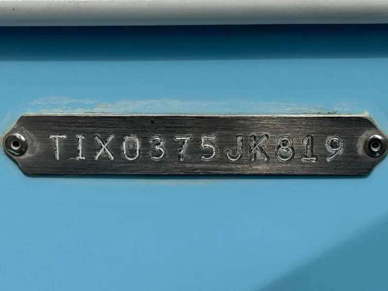 Slide: The Image of Hull identification number on 2019 Tigé R21 boat, TIX0375JK819, on blue background. - 34