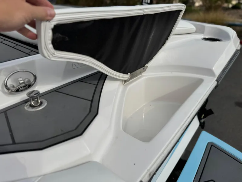 Slide: The Image of 2019 Tigé R21 boat storage compartment with open lid, showcasing sleek design and functionality. - 8