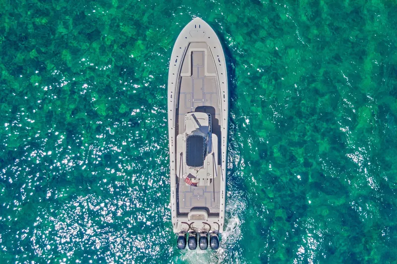 Slide: The Image of Aerial view of 2013 Invincible 42 Open Fisherman boat on clear turquoise water. - 12