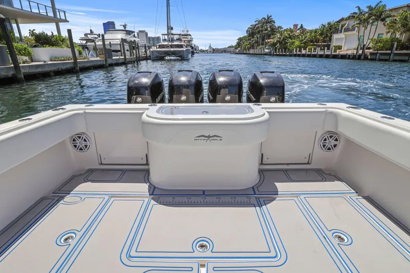 Slide: The Image of 2013 Invincible 42 Open Fisherman boat with four engines, docked in a scenic marina. - 14