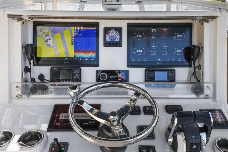 Slide: The Image of Helm of 2013 Invincible 42 Open Fisherman with advanced navigation displays and controls. - 23