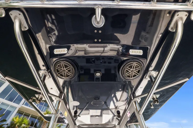 Slide: The Image of 2013 Invincible 42 Open Fisherman boat, featuring speakers and lights on the overhead console. - 24