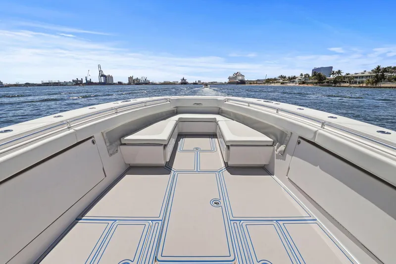 Slide: The Image of 2013 Invincible 42 Open Fisherman boat on water, spacious deck, clear sky. - 29