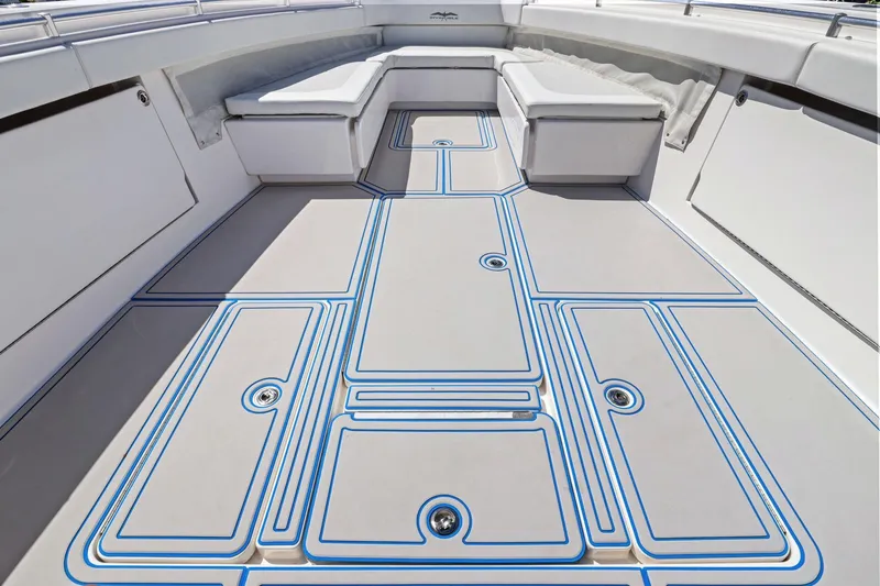 Slide: The Image of 2013 Invincible 42 Open Fisherman boat deck with cushioned seating and sleek design. - 30