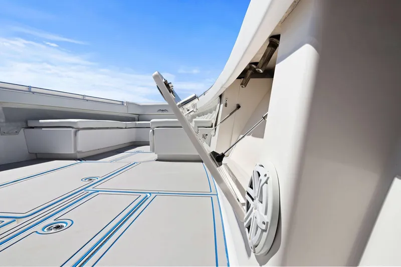 Slide: The Image of 2013 Invincible 42 Open Fisherman boat deck with seating and storage compartments. - 32