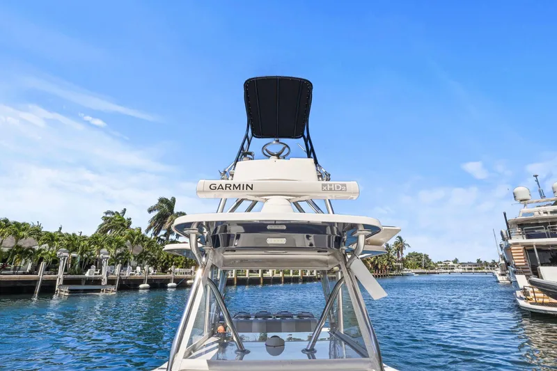 Slide: The Image of 2013 Invincible 42 Open Fisherman boat with Garmin equipment, docked in a scenic marina. - 35
