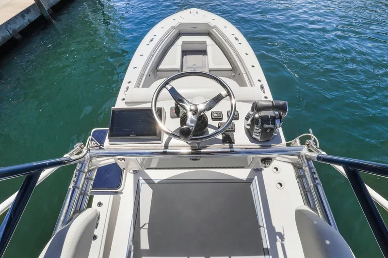 Slide: The Image of 2013 Invincible 42 Open Fisherman boat helm with steering wheel and controls. - 38