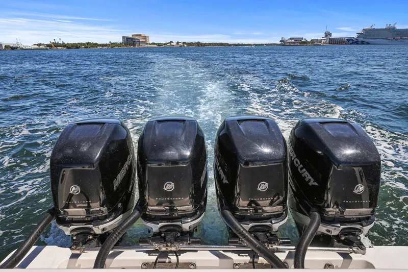 Slide: The Image of Four Mercury outboard engines on a 2013 Invincible 42 Open Fisherman boat in open water. - 41