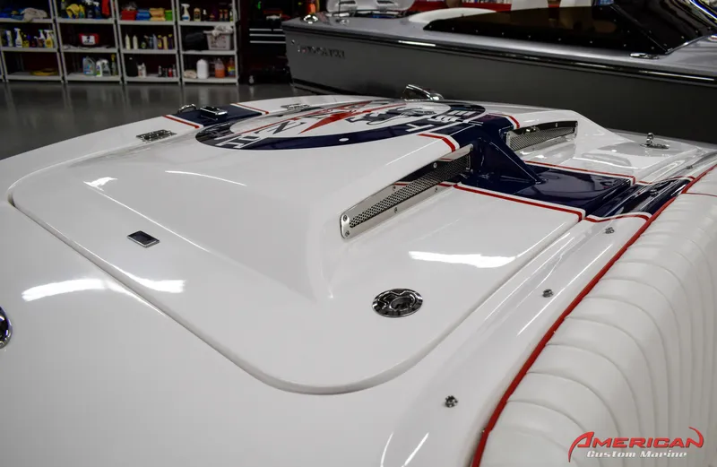 Slide: The Image of 2022 Donzi 22 Classic boat with sleek white and blue design in a showroom. - 11