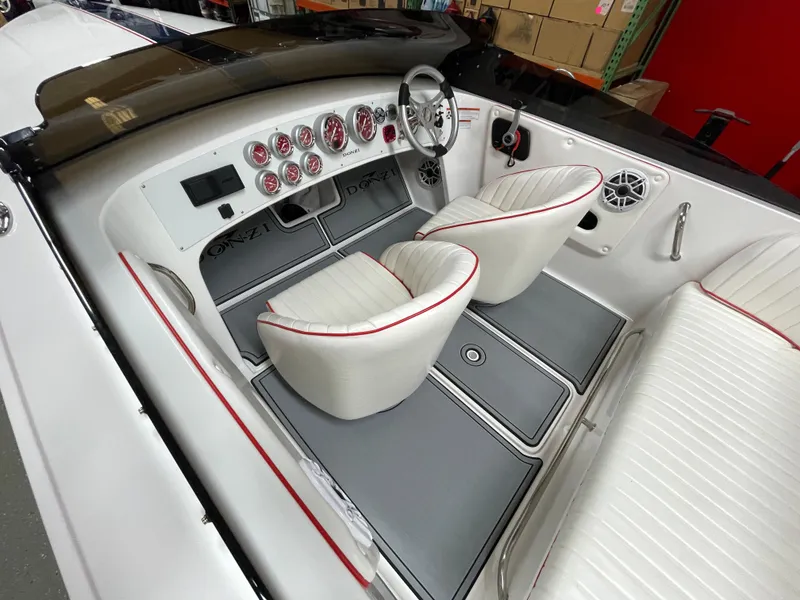 Slide: The Image of 2022 Donzi 22 Classic boat interior with white seats, red trim, and detailed dashboard. - 15