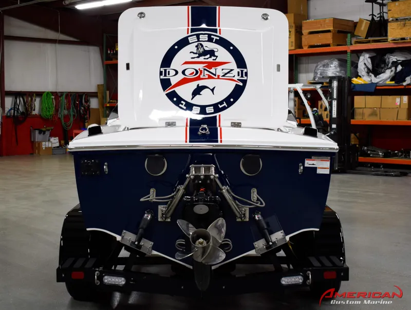 Slide: The Image of 2022 Donzi 22 Classic boat in a garage, showcasing rear design and logo. - 9
