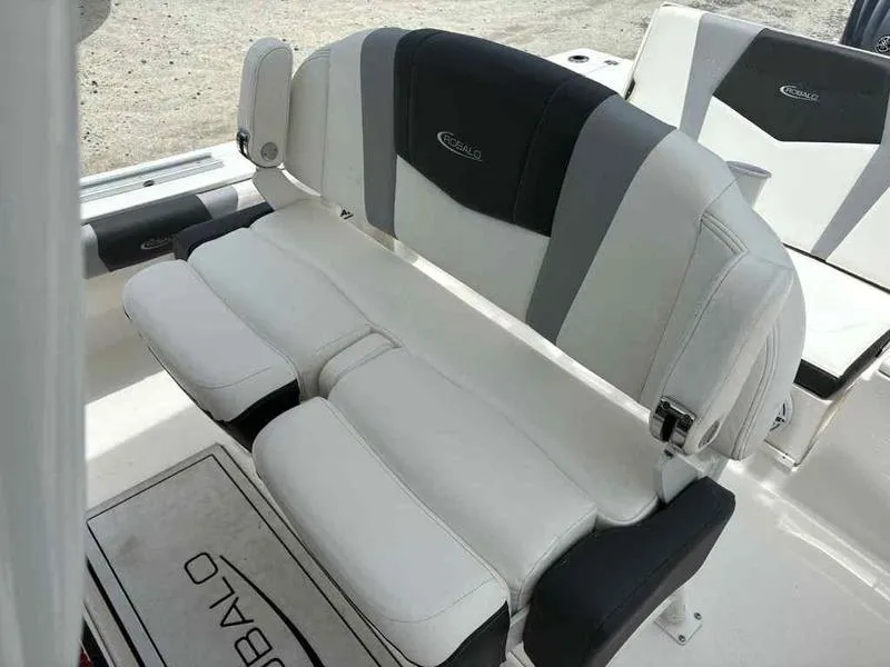 Slide: The Image of 2024 Robalo 246 Cayman boat seating with white and black upholstery. - 10