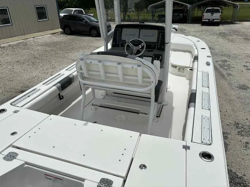 Slide: The Image of 2024 Robalo 246 Cayman boat interior with steering console and seating. - 13