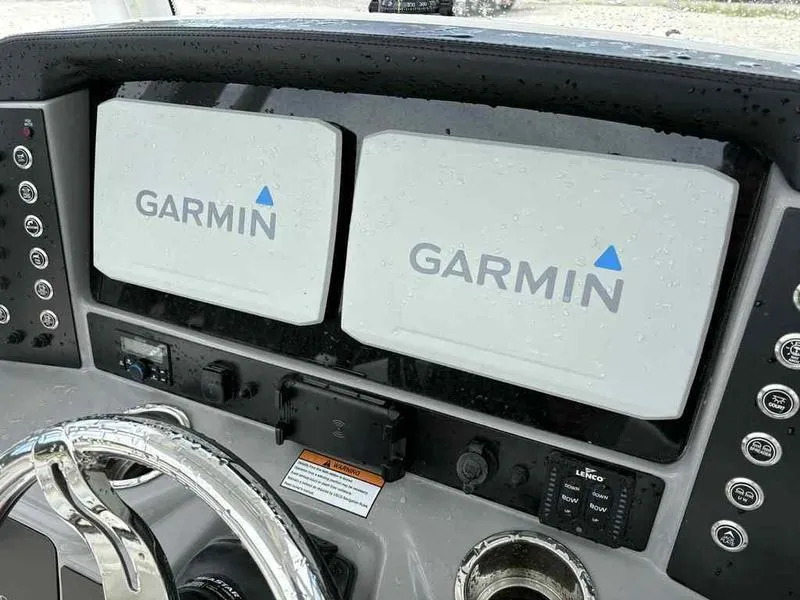 Slide: The Image of Dashboard of 2024 Robalo 246 Cayman with dual Garmin displays. - 14